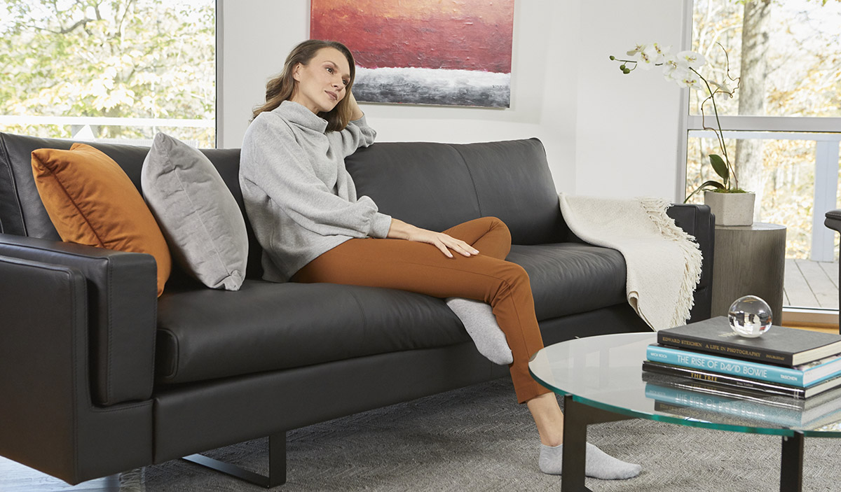 family sitting on a sofa—from high-quality furniture brand Fjords—that has been in their home for years